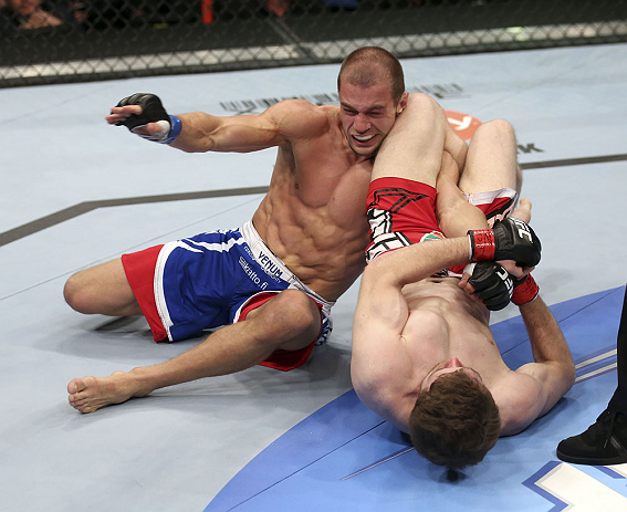 CALGARY, CANADA - JULY 21: (R-L) Mitch Clarke attempts an armbar against Anton Kuivanen during their lightweight bout at UFC 149 inside the Scotiabank Saddledome on July 21, 2012 in Calgary, Alberta, Canada.  (Photo by Nick Laham/Zuffa LLC/Zuffa LLC via Getty Images)