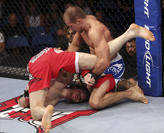 CALGARY, CANADA - JULY 21: (L-R) Mitch Clarke gets flipped by Anton Kuivanen during their lightweight bout at UFC 149 inside the Scotiabank Saddledome on July 21, 2012 in Calgary, Alberta, Canada.  (Photo by Nick Laham/Zuffa LLC/Zuffa LLC via Getty Images)