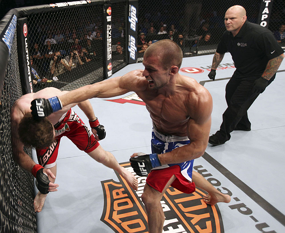 CALGARY, CANADA - JULY 21:  (R-L) Anton Kuivanen throws a punch at Mitch Clarke during their lightweight bout at UFC 149 inside the Scotiabank Saddledome on July 21, 2012 in Calgary, Alberta, Canada.  (Photo by Nick Laham/Zuffa LLC/Zuffa LLC via Getty Images)