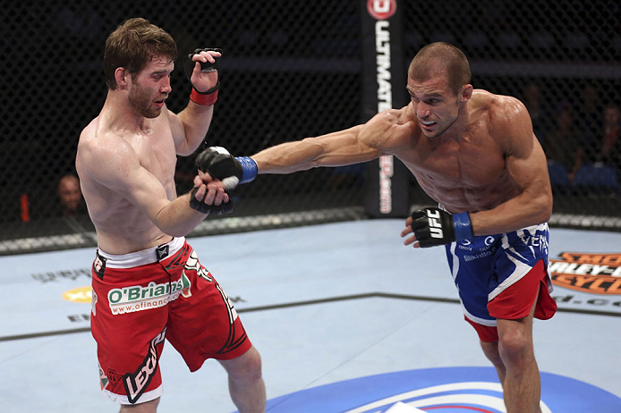 CALGARY, CANADA - JULY 21:  (R-L) Anton Kuivanen throws a punch at Mitch Clarke during their lightweight bout at UFC 149 inside the Scotiabank Saddledome on July 21, 2012 in Calgary, Alberta, Canada.  (Photo by Nick Laham/Zuffa LLC/Zuffa LLC via Getty Images)