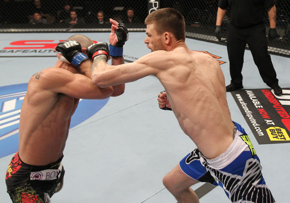 OMAHA, NE - FEBRUARY 15:  (R-L) Tim Means punches Bernardo Magalhaes during the UFC on FUEL TV event at Omaha Civic Auditorium on February 15, 2012 in Omaha, Nebraska.  (Photo by Josh Hedges/Zuffa LLC/Zuffa LLC via Getty Images) *** Local Caption *** Tim Means; Bernardo Magalhaes
