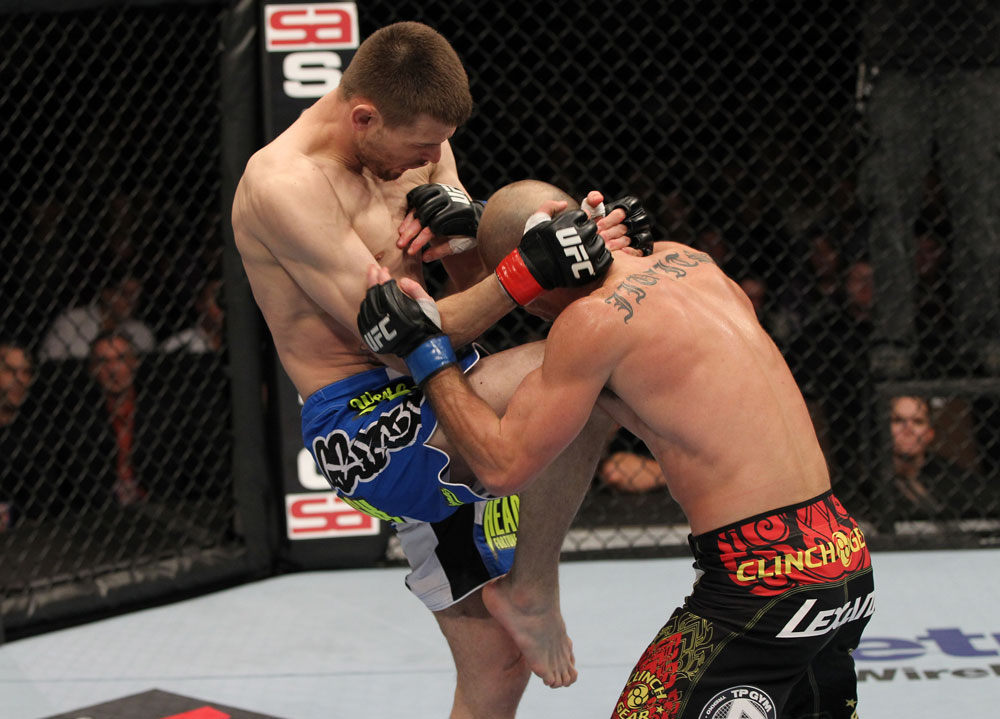 OMAHA, NE - FEBRUARY 15: (L-R) Tim Means delivers a knee strike against Bernardo Magalhaes during the UFC on FUEL TV event at Omaha Civic Auditorium on February 15, 2012 in Omaha, Nebraska. (Photo by Josh Hedges/Zuffa LLC/Zuffa LLC via Getty Images) *** Local Caption *** Tim Means; Bernardo Magalhaes