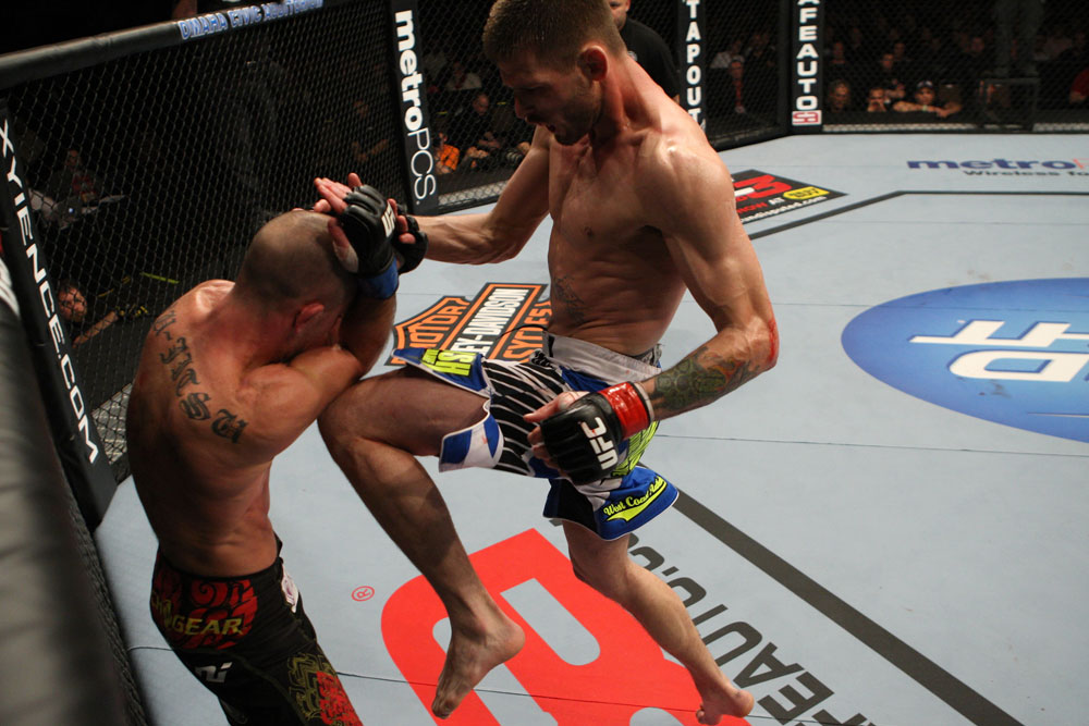 OMAHA, NE - FEBRUARY 15: (R-L) Tim Means delivers a knee strike against Bernardo Magalhaes during the UFC on FUEL TV event at Omaha Civic Auditorium on February 15, 2012 in Omaha, Nebraska. (Photo by Josh Hedges/Zuffa LLC/Zuffa LLC via Getty Images) *** Local Caption *** Tim Means; Bernardo Magalhaes