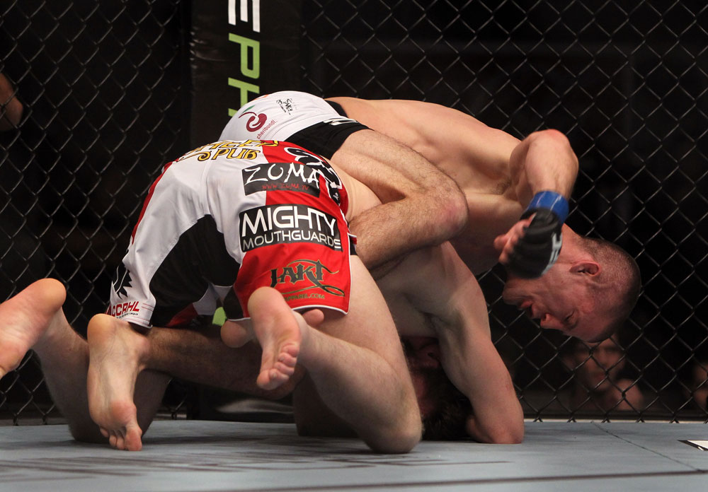 TORONTO, ON - DECEMBER 10:  (R-L) John Cholish punches Mitch Clarke during the UFC 140 event at Air Canada Centre on December 10, 2011 in Toronto, Ontario, Canada.  (Photo by Josh Hedges/Zuffa LLC/Zuffa LLC via Getty Images)