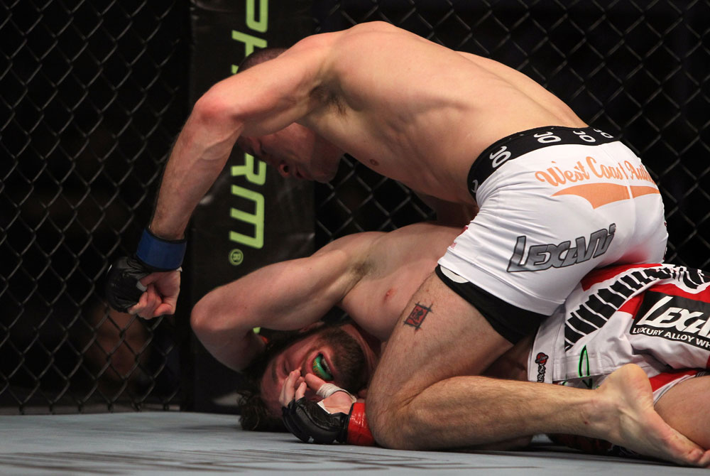 TORONTO, ON - DECEMBER 10:  (R-L) John Cholish punches Mitch Clarke during the UFC 140 event at Air Canada Centre on December 10, 2011 in Toronto, Ontario, Canada.  (Photo by Josh Hedges/Zuffa LLC/Zuffa LLC via Getty Images)