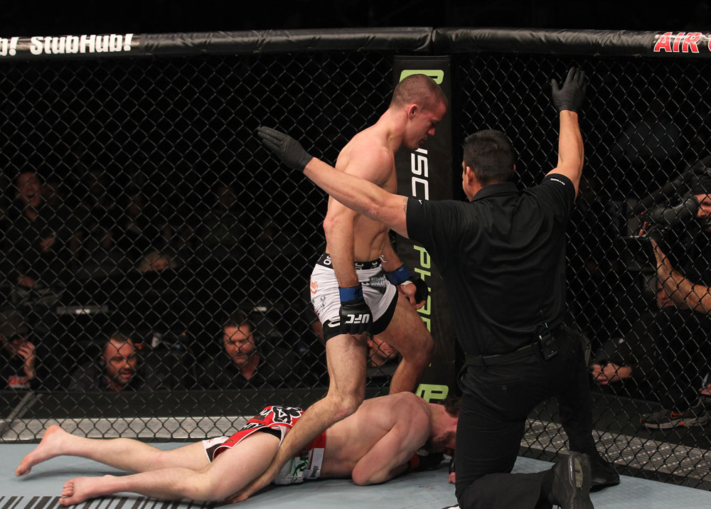 TORONTO, ON - DECEMBER 10:  (R-L) Referee John McCarthy stops the bout as John Cholish (standing) defeats Mitch Clarke by TKO during the UFC 140 event at Air Canada Centre on December 10, 2011 in Toronto, Canada.  (Photo by Nick Laham/Zuffa LLC/Zuffa LLC)