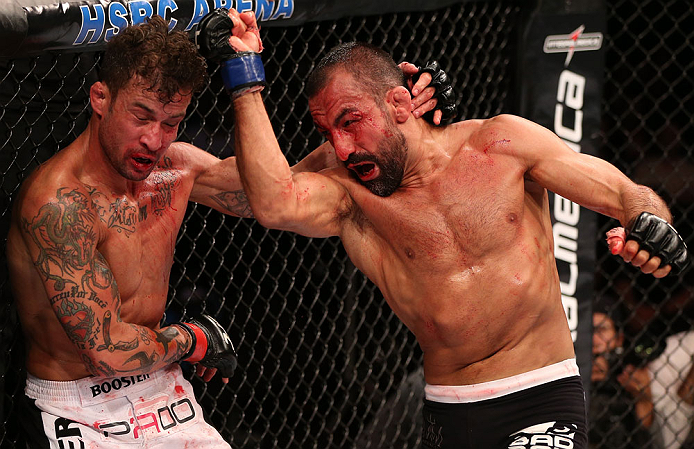 RIO DE JANEIRO, BRAZIL - OCTOBER 13:  (R-L) Reza Madadi punches Cristiano Marcello during their lightweight fight at UFC 153 inside HSBC Arena on October 13, 2012 in Rio de Janeiro, Brazil.  (Photo by Josh Hedges/Zuffa LLC/Zuffa LLC via Getty Images)
