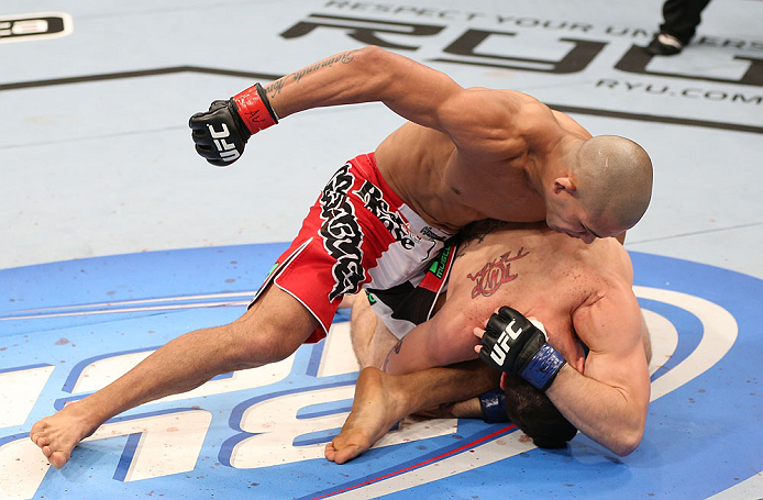 RIO DE JANEIRO, BRAZIL - OCTOBER 13:  (L-R) Diego Brandao punches Joey Gambino during their featherweight fight at UFC 153 inside HSBC Arena on October 13, 2012 in Rio de Janeiro, Brazil.  (Photo by Josh Hedges/Zuffa LLC/Zuffa LLC via Getty Images)