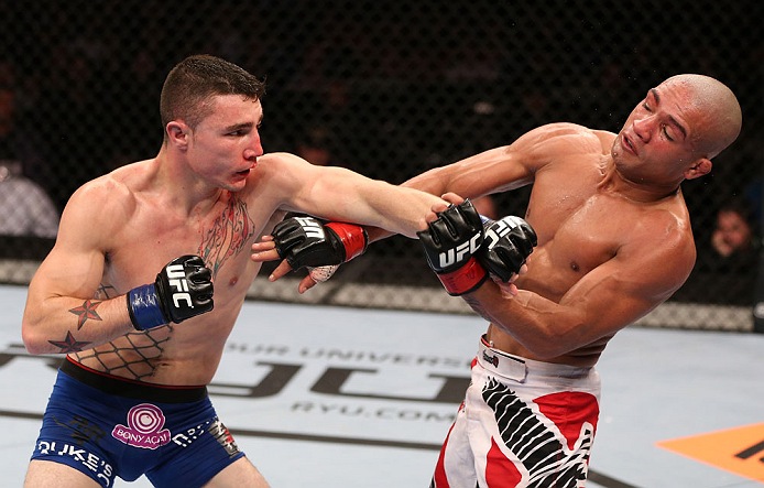 RIO DE JANEIRO, BRAZIL - OCTOBER 13:  (L-R) Joey Gambino punches Diego Brandao during their featherweight fight at UFC 153 inside HSBC Arena on October 13, 2012 in Rio de Janeiro, Brazil.  (Photo by Josh Hedges/Zuffa LLC/Zuffa LLC via Getty Images)