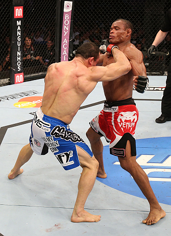 RIO DE JANEIRO, BRAZIL - OCTOBER 13:  (L-R) Gleison Tibau punches Francisco Trinaldo during their lightweight fight at UFC 153 inside HSBC Arena on October 13, 2012 in Rio de Janeiro, Brazil.  (Photo by Josh Hedges/Zuffa LLC/Zuffa LLC via Getty Images)