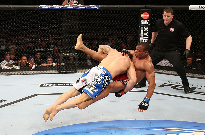 RIO DE JANEIRO, BRAZIL - OCTOBER 13:  (L-R) Gleison Tibau takes down Francisco Trinaldo during their lightweight fight at UFC 153 inside HSBC Arena on October 13, 2012 in Rio de Janeiro, Brazil.  (Photo by Josh Hedges/Zuffa LLC/Zuffa LLC via Getty Images)