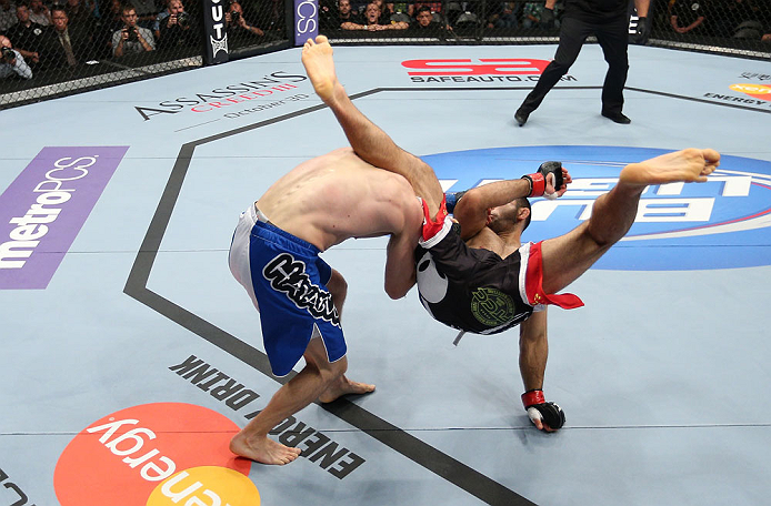 MINNEAPOLIS, MN - OCTOBER 05: (R-L) Darren Uyenoyama throws a flying kick against Phil Harris during their flyweight fight at the UFC on FX event at Target Center on October 5, 2012 in Minneapolis, Minnesota. (Photo by Josh Hedges/Zuffa LLC/Zuffa LLC via Getty Images)