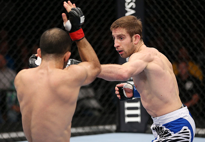 MINNEAPOLIS, MN - OCTOBER 05: (R-L) Phil Harris punches Darren Uyenoyama during their flyweight fight at the UFC on FX event at Target Center on October 5, 2012 in Minneapolis, Minnesota. (Photo by Josh Hedges/Zuffa LLC/Zuffa LLC via Getty Images)
