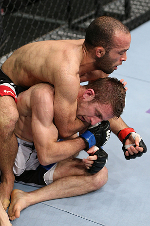 MINNEAPOLIS, MN - OCTOBER 05: (L-R) Darren Uyenoyama secures a rear choke submission against Phil Harris during their flyweight fight at the UFC on FX event at Target Center on October 5, 2012 in Minneapolis, Minnesota. (Photo by Josh Hedges/Zuffa LLC/Zuffa LLC via Getty Images)