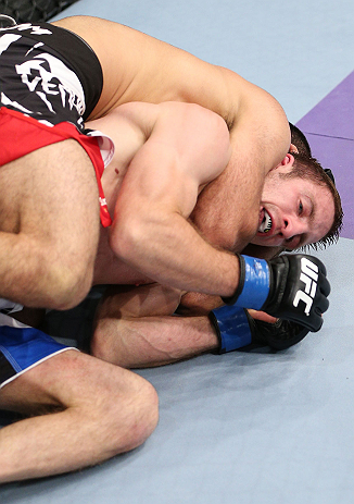 MINNEAPOLIS, MN - OCTOBER 05: (L-R) Darren Uyenoyama secures a rear choke submission against Phil Harris during their flyweight fight at the UFC on FX event at Target Center on October 5, 2012 in Minneapolis, Minnesota. (Photo by Josh Hedges/Zuffa LLC/Zuffa LLC via Getty Images)