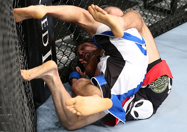 MINNEAPOLIS, MN - OCTOBER 05: (R-L) Darren Uyenoyama secures a rear choke submission against Phil Harris during their flyweight fight at the UFC on FX event at Target Center on October 5, 2012 in Minneapolis, Minnesota. (Photo by Josh Hedges/Zuffa LLC/Zuffa LLC via Getty Images)