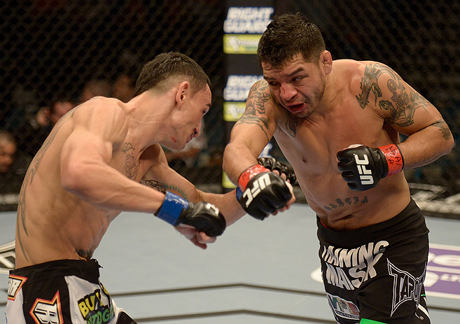 LAS VEGAS, NV - DECEMBER 29:  (L-R) Leonard Garcia punches Max Holloway during their featherweight fight at UFC 155 on December 29, 2012 at MGM Grand Garden Arena in Las Vegas, Nevada. (Photo by Donald Miralle/Zuffa LLC/Zuffa LLC via Getty Images) *** Local Caption *** Leonard Garcia; Max Holloway