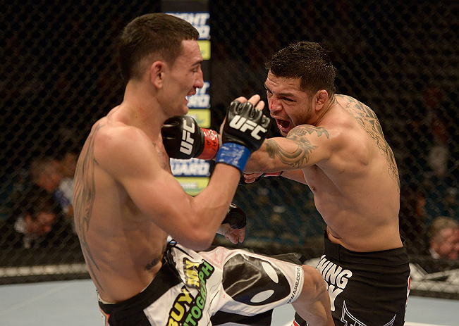 LAS VEGAS, NV - DECEMBER 29:  (L-R) Leonard Garcia punches Max Holloway during their featherweight fight at UFC 155 on December 29, 2012 at MGM Grand Garden Arena in Las Vegas, Nevada. (Photo by Donald Miralle/Zuffa LLC/Zuffa LLC via Getty Images) *** Local Caption *** Leonard Garcia; Max Holloway