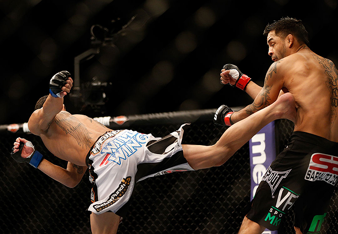 LAS VEGAS, NV - DECEMBER 29:  (L-R) Max Holloway kicks Leonard Garcia during their featherweight fight at UFC 155 on December 29, 2012 at MGM Grand Garden Arena in Las Vegas, Nevada. (Photo by Josh Hedges/Zuffa LLC/Zuffa LLC via Getty Images) *** Local Caption *** Leonard Garcia; Max Holloway