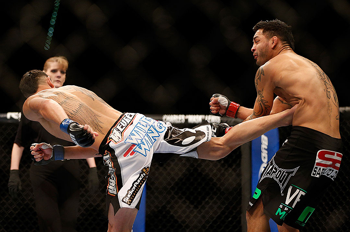 LAS VEGAS, NV - DECEMBER 29:  (L-R) Max Holloway kicks Leonard Garcia during their featherweight fight at UFC 155 on December 29, 2012 at MGM Grand Garden Arena in Las Vegas, Nevada. (Photo by Josh Hedges/Zuffa LLC/Zuffa LLC via Getty Images) *** Local Caption *** Leonard Garcia; Max Holloway