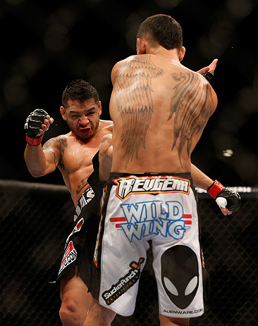 LAS VEGAS, NV - DECEMBER 29:  (L-R) Leonard Garcia kicks Max Holloway during their featherweight fight at UFC 155 on December 29, 2012 at MGM Grand Garden Arena in Las Vegas, Nevada. (Photo by Josh Hedges/Zuffa LLC/Zuffa LLC via Getty Images) *** Local Caption *** Leonard Garcia; Max Holloway