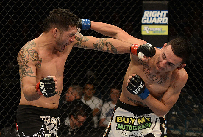 LAS VEGAS, NV - DECEMBER 29:  (L-R) Leonard Garcia punches Max Holloway during their featherweight fight at UFC 155 on December 29, 2012 at MGM Grand Garden Arena in Las Vegas, Nevada. (Photo by Donald Miralle/Zuffa LLC/Zuffa LLC via Getty Images) *** Local Caption *** Leonard Garcia; Max Holloway