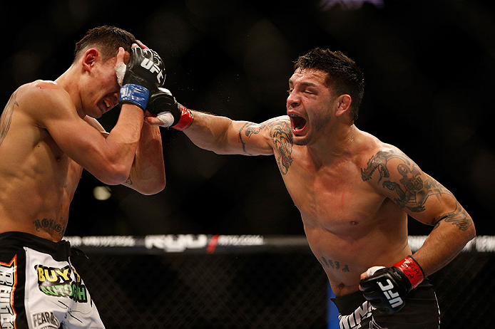 LAS VEGAS, NV - DECEMBER 29:  (R-L) Leonard Garcia punches Max Holloway during their featherweight fight at UFC 155 on December 29, 2012 at MGM Grand Garden Arena in Las Vegas, Nevada. (Photo by Josh Hedges/Zuffa LLC/Zuffa LLC via Getty Images) *** Local Caption *** Leonard Garcia; Max Holloway