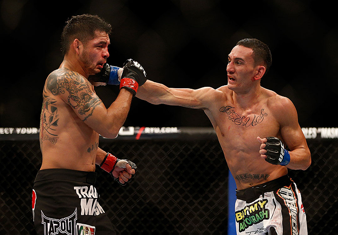 LAS VEGAS, NV - DECEMBER 29:  (R-L) Max Holloway punches Leonard Garcia during their featherweight fight at UFC 155 on December 29, 2012 at MGM Grand Garden Arena in Las Vegas, Nevada. (Photo by Josh Hedges/Zuffa LLC/Zuffa LLC via Getty Images) *** Local Caption *** Leonard Garcia; Max Holloway