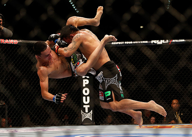 LAS VEGAS, NV - DECEMBER 29:  (R-L) Leonard Garcia slams Max Holloway during their featherweight fight at UFC 155 on December 29, 2012 at MGM Grand Garden Arena in Las Vegas, Nevada. (Photo by Josh Hedges/Zuffa LLC/Zuffa LLC via Getty Images) *** Local Caption *** Leonard Garcia; Max Holloway