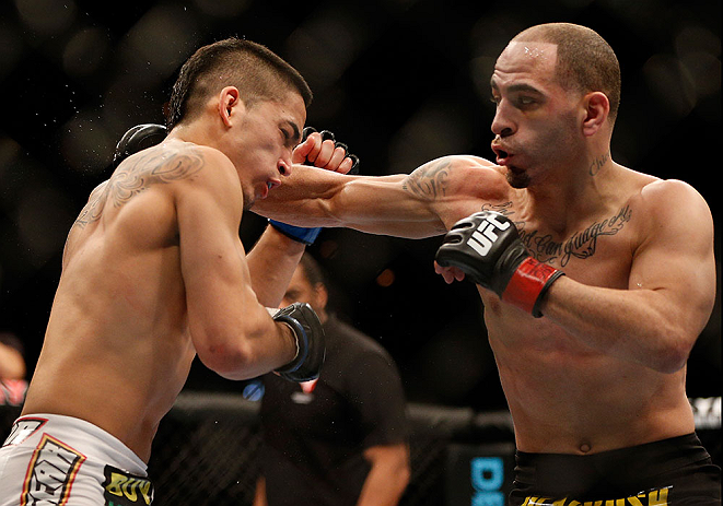 LAS VEGAS, NV - FEBRUARY 02: (R-L) Chico Camus punches Dustin Kimura during their bantamweight fight at UFC 156 on February 2, 2013 at the Mandalay Bay Events Center in Las Vegas, Nevada. (Photo by Josh Hedges/Zuffa LLC/Zuffa LLC via Getty Images) *** Local Caption *** Chico Camus; Dustin Kimura