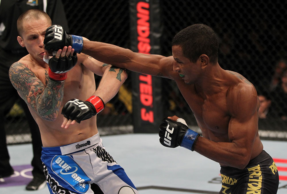 FAIRFAX, VA - MAY 15:  (R-L) Johnny Eduardo punches Jeff Curran in a bantamweight bout during the UFC on Fuel TV event at Patriot Center on May 15, 2012 in Fairfax, Virginia.  (Photo by Josh Hedges/Zuffa LLC/Zuffa LLC via Getty Images)