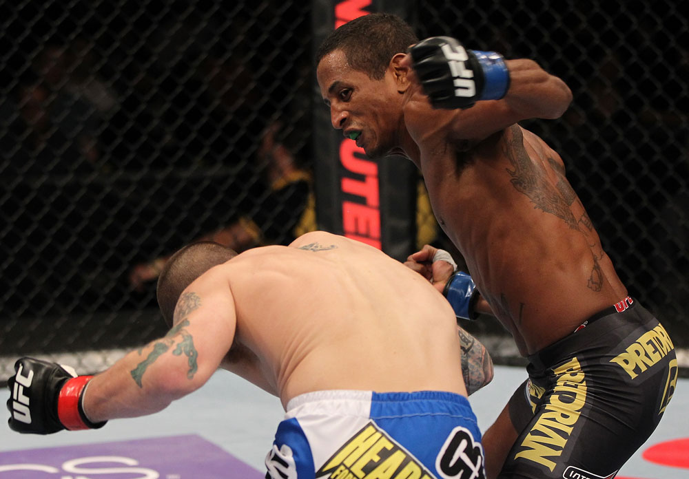 FAIRFAX, VA - MAY 15:  (R-L) Johnny Eduardo punches Jeff Curran in a bantamweight bout during the UFC on Fuel TV event at Patriot Center on May 15, 2012 in Fairfax, Virginia.  (Photo by Josh Hedges/Zuffa LLC/Zuffa LLC via Getty Images)