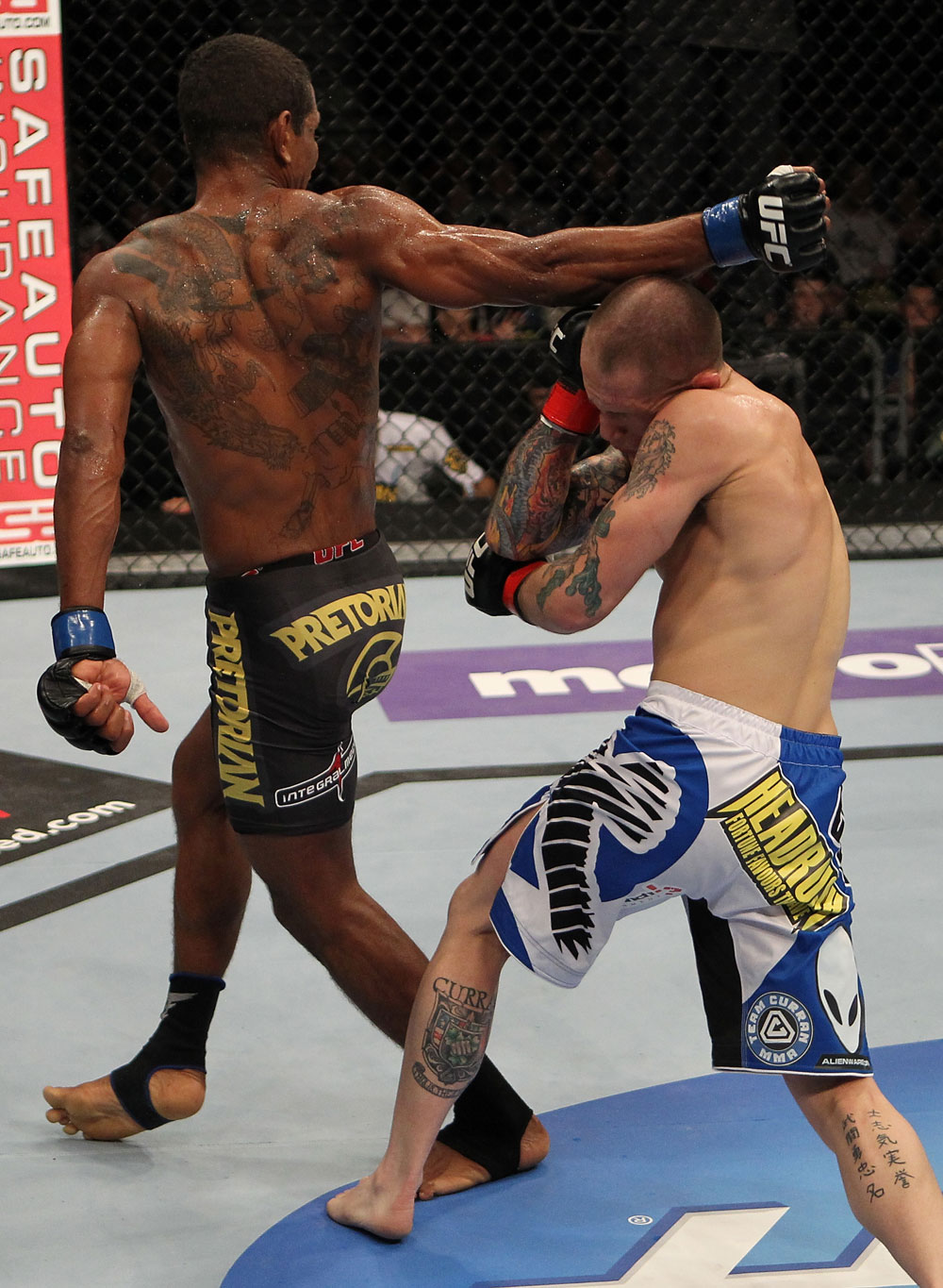 FAIRFAX, VA - MAY 15:  (L-R) Johnny Eduardo delivers a spinning back fist against Jeff Curran in a bantamweight bout during the UFC on Fuel TV event at Patriot Center on May 15, 2012 in Fairfax, Virginia.  (Photo by Josh Hedges/Zuffa LLC/Zuffa LLC via Getty Images)