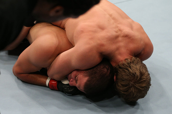 NOTTINGHAM, ENGLAND - SEPTEMBER 29: (R-L) Gunnar Nelson secures a rear choke submission against DaMarques Johnson during their catchweight fight at the UFC on Fuel TV event at Capital FM Arena on September 29, 2012 in Nottingham, England. (Photo by Josh Hedges/Zuffa LLC/Zuffa LLC via Getty Images)