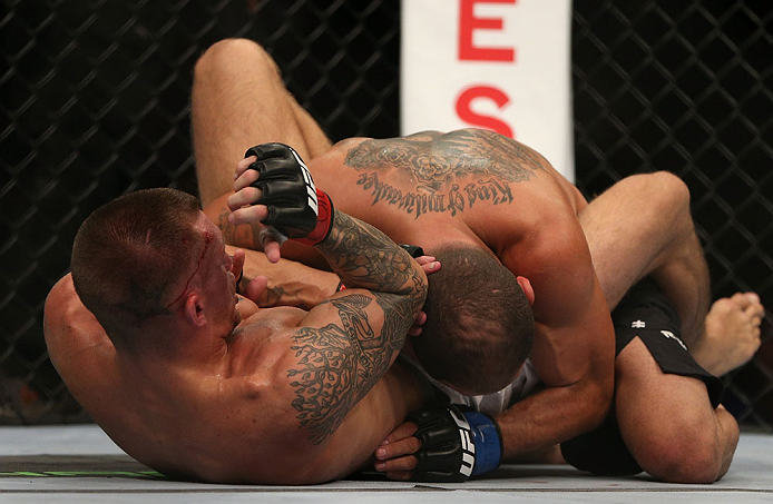 DENVER, CO - AUGUST 11: (L-R) Dustin Pague delivers an elbow strike against Chico Camus on the ground during their bantamweight bout at UFC 150 inside Pepsi Center on August 11, 2012 in Denver, Colorado. (Photo by Josh Hedges/Zuffa LLC/Zuffa LLC via Getty Images)
