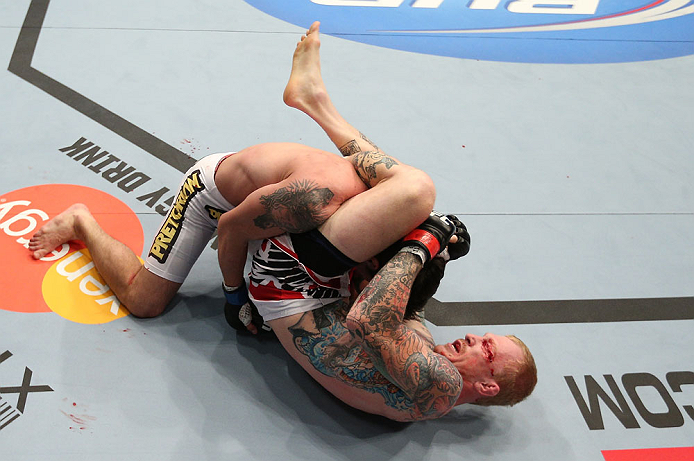 MINNEAPOLIS, MN - OCTOBER 05: (R-L) Bart Palaszewski attempts a triangle choke submission against Diego Nunes during their featherweight fight at the UFC on FX event at Target Center on October 5, 2012 in Minneapolis, Minnesota. (Photo by Josh Hedges/Zuffa LLC/Zuffa LLC via Getty Images)