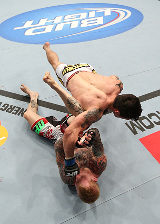 MINNEAPOLIS, MN - OCTOBER 05: Diego Nunes (top) punches Bart Palaszewski during their featherweight fight at the UFC on FX event at Target Center on October 5, 2012 in Minneapolis, Minnesota. (Photo by Josh Hedges/Zuffa LLC/Zuffa LLC via Getty Images)