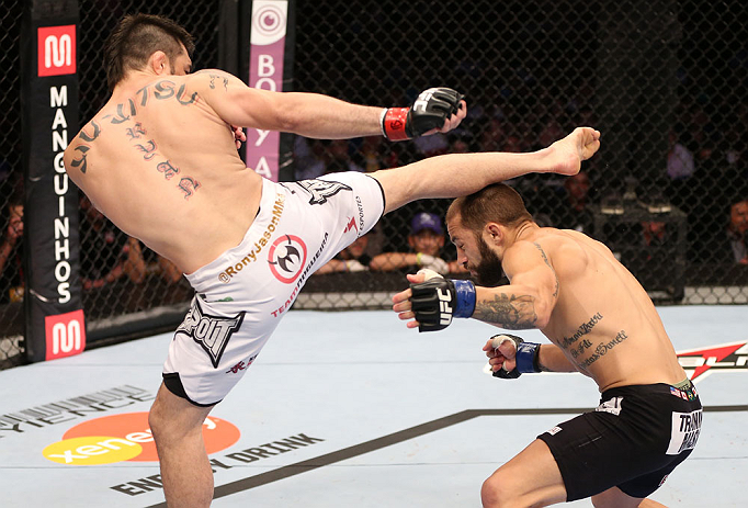 RIO DE JANEIRO, BRAZIL - OCTOBER 13:  (L-R) Rony "Jason" Mariano Bezerra kicks Sam Sicilia during their featherweight fight at UFC 153 inside HSBC Arena on October 13, 2012 in Rio de Janeiro, Brazil.  (Photo by Josh Hedges/Zuffa LLC/Zuffa LLC via Getty Images)