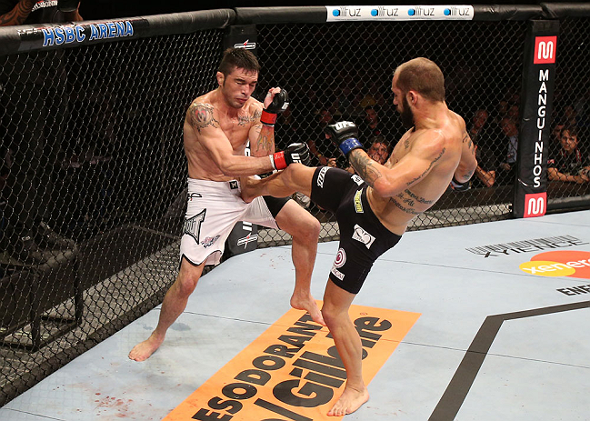 RIO DE JANEIRO, BRAZIL - OCTOBER 13:  (R-L) Sam Sicilia kicks Rony "Jason" Mariano Bezerra during their featherweight fight at UFC 153 inside HSBC Arena on October 13, 2012 in Rio de Janeiro, Brazil.  (Photo by Josh Hedges/Zuffa LLC/Zuffa LLC via Getty Images)