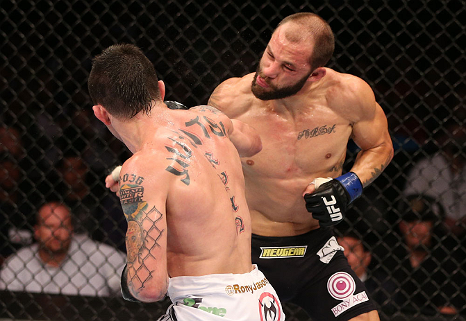 RIO DE JANEIRO, BRAZIL - OCTOBER 13:  (L-R) Rony "Jason" Mariano Bezerra punches Sam Sicilia during their featherweight fight at UFC 153 inside HSBC Arena on October 13, 2012 in Rio de Janeiro, Brazil.  (Photo by Josh Hedges/Zuffa LLC/Zuffa LLC via Getty Images)