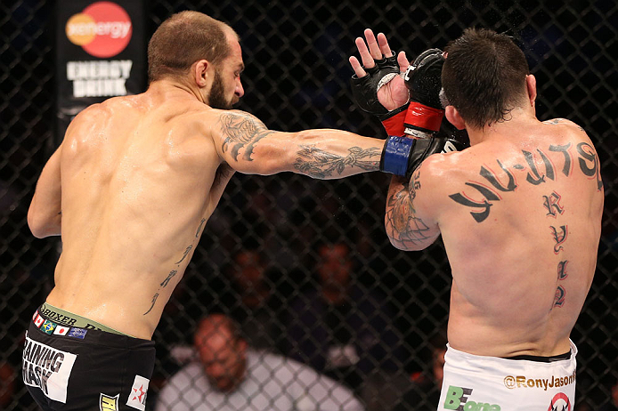 RIO DE JANEIRO, BRAZIL - OCTOBER 13:  (L-R) Sam Sicilia punches Rony "Jason" Mariano Bezerra during their featherweight fight at UFC 153 inside HSBC Arena on October 13, 2012 in Rio de Janeiro, Brazil.  (Photo by Josh Hedges/Zuffa LLC/Zuffa LLC via Getty Images)