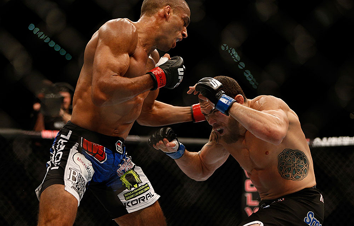 (L-R) Edson Barboza punches Rafaello Oliveira in their lightweight fight during the UFC 162 event inside the MGM Grand Garden Arena on July 6, 2013 in Las Vegas, NV. (Photo by Josh Hedges/Zuffa LLC)