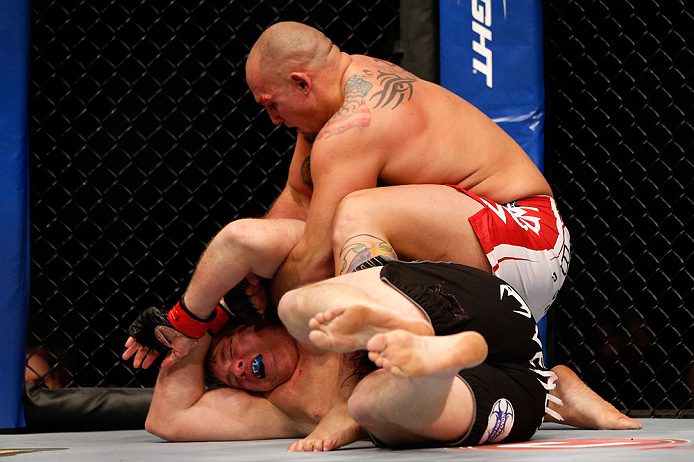CHICAGO, IL - JANUARY 26:  Shawn Jordan (Top) punches Mike Russow (Bottom) during their Heavyweight Bout part of UFC on FOX at United Center on January 26, 2013 in Chicago, Illinois.  (Photo by Josh Hedges/Zuffa LLC/Zuffa LLC Via Getty Images)