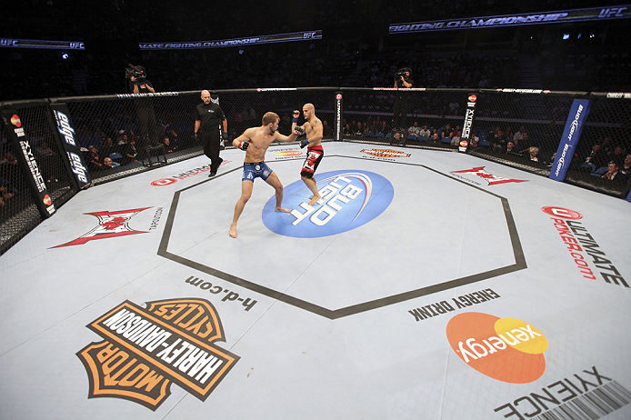 CALGARY, CANADA - JULY 21: (L-R) Bryan Caraway throws a punch at Mitch Gagnon during their bantamweight bout at UFC 149 inside the Scotiabank Saddledome on July 21, 2012 in Calgary, Alberta, Canada.  (Photo by Nick Laham/Zuffa LLC/Zuffa LLC via Getty Images)