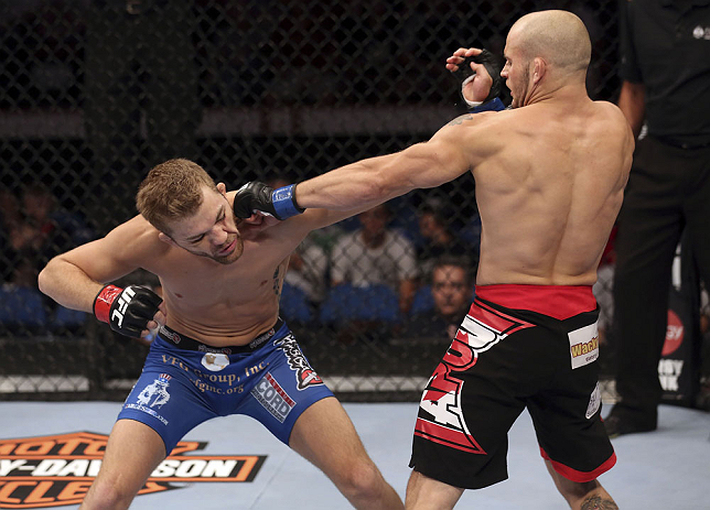 CALGARY, CANADA - JULY 21:  (R-L) Mitch Gagnon lands a punch on Bryan Caraway during their bantamweight bout at UFC 149 inside the Scotiabank Saddledome on July 21, 2012 in Calgary, Alberta, Canada.  (Photo by Nick Laham/Zuffa LLC/Zuffa LLC via Getty Images)