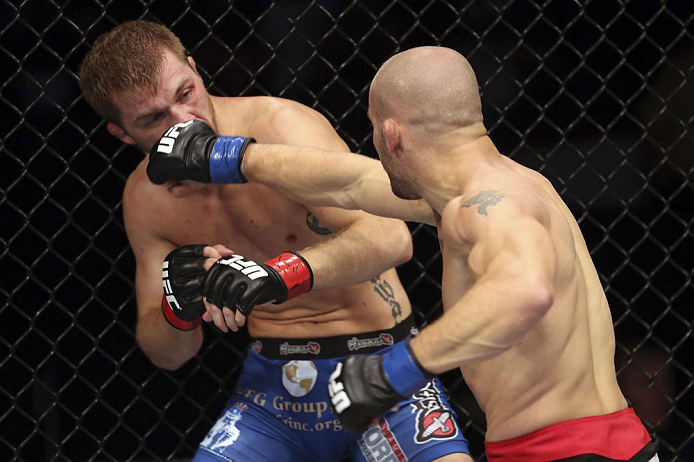 CALGARY, CANADA - JULY 21:  (R-L) Mitch Gagnon lands a punch on Bryan Caraway during their bantamweight bout at UFC 149 inside the Scotiabank Saddledome on July 21, 2012 in Calgary, Alberta, Canada.  (Photo by Nick Laham/Zuffa LLC/Zuffa LLC via Getty Images)