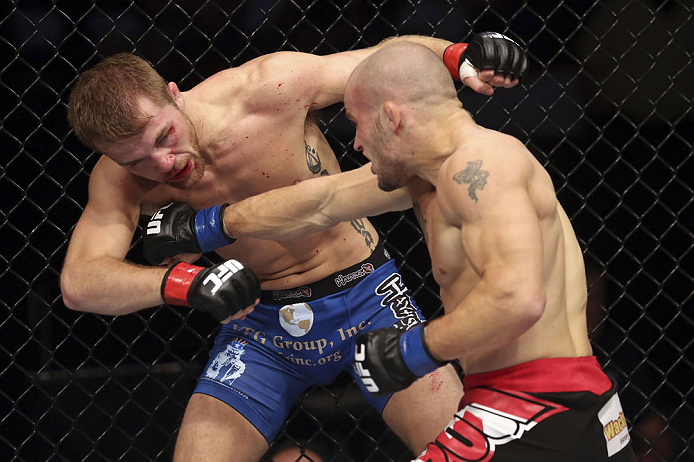 CALGARY, CANADA - JULY 21: (R-L) Mitch Gagnon lands a punch on Bryan Caraway during their bantamweight bout at UFC 149 inside the Scotiabank Saddledome on July 21, 2012 in Calgary, Alberta, Canada.  (Photo by Nick Laham/Zuffa LLC/Zuffa LLC via Getty Images)