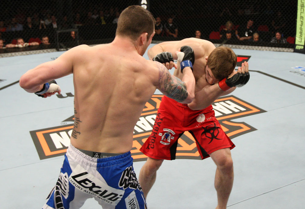 SYDNEY, AUSTRALIA - MARCH 03: (L-R) Jake Hecht punches TJ Waldburger in a welterweight bout during the UFC on FX event at Allphones Arena on March 3, 2012 in Sydney, Australia. (Photo by Josh Hedges/Zuffa LLC/Zuffa LLC via Getty Images) *** Local Caption *** TJ Waldburger; Jake Hecht