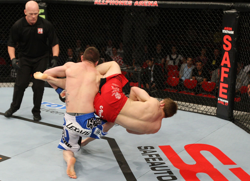 SYDNEY, AUSTRALIA - MARCH 03: (R-L) TJ Waldburger secures an arm bar submission against Jake Hecht in their welterweight bout during the UFC on FX event at Allphones Arena on March 3, 2012 in Sydney, Australia. (Photo by Josh Hedges/Zuffa LLC/Zuffa LLC via Getty Images) *** Local Caption *** TJ Waldburger; Jake Hecht