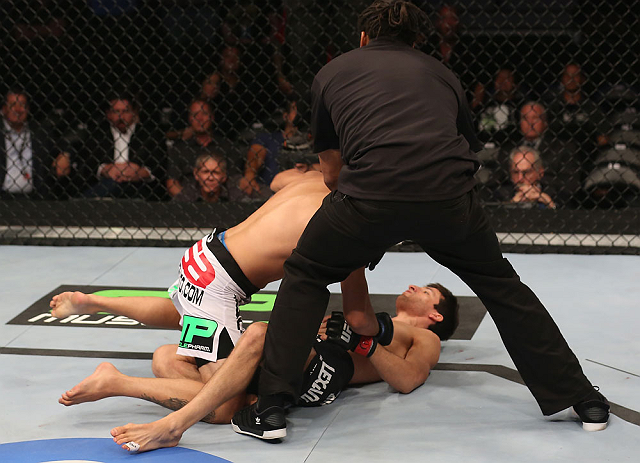 DENVER, CO - AUGUST 11: Referee Herb Dean steps in to stop the bout as Erik Perez (L) knocks out Ken Stone during their bantamweight bout at UFC 150 inside Pepsi Center on August 11, 2012 in Denver, Colorado. (Photo by Nick Laham/Zuffa LLC/Zuffa LLC via Getty Images)